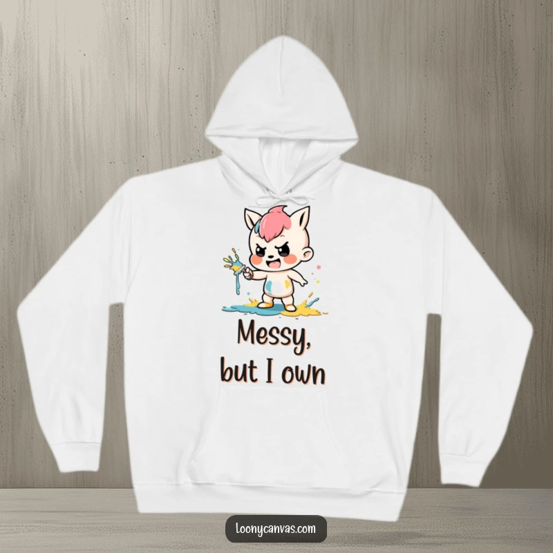 Funny hoodie depicting a mischievous character playfully splattering vibrant paint, perfect for art enthusiasts and humor lovers.