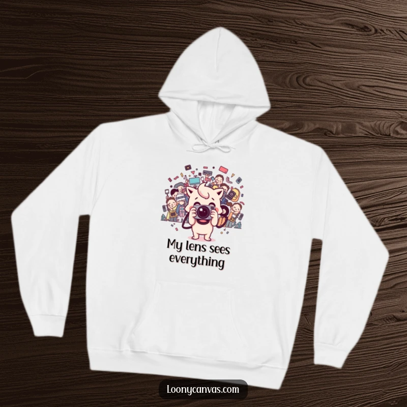 Funny happy Kawaii camera character takes a chaotic photo, depicted on a warm hoodie for cozy creativity.