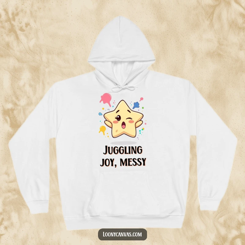 Funny hoodie depicting a surprised star character winking while juggling paint splatters, perfect for cozy, artistic, and humorous moments.