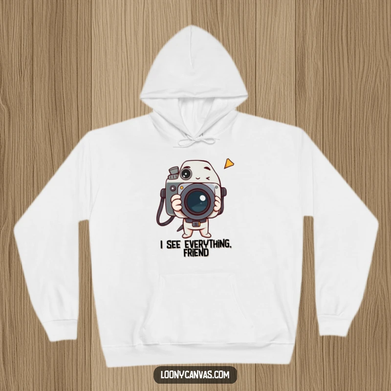 Funny hoodie with a delighted camera character intently capturing a fleeting, surreal, and humorous moment.