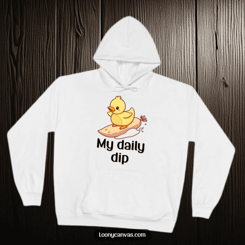 Funny hoodie with a playful rubber ducky character surfing on a teabag, offering cozy comfort and humorous water-themed fun.