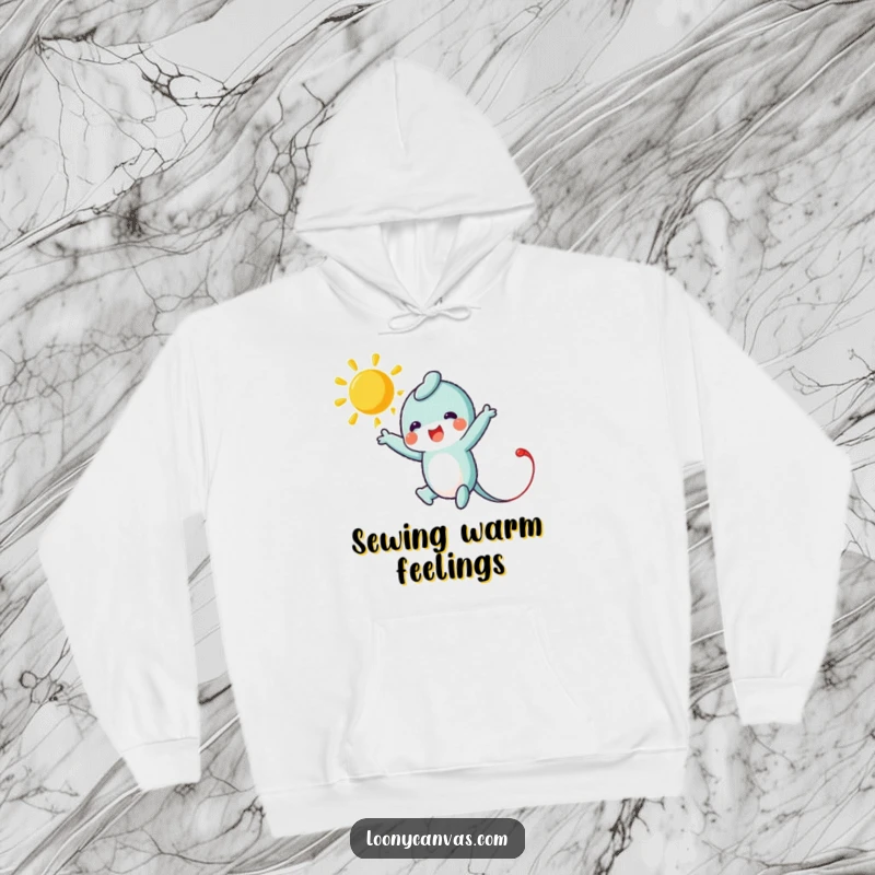 Funny hoodie with a leaping needle character stitching a bright sun, offering comfort and a touch of handmade joy.