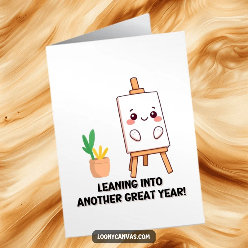Funny free printable birthday card: A smiling kawaii easel character tilts dangerously, holding an art piece with a grin.