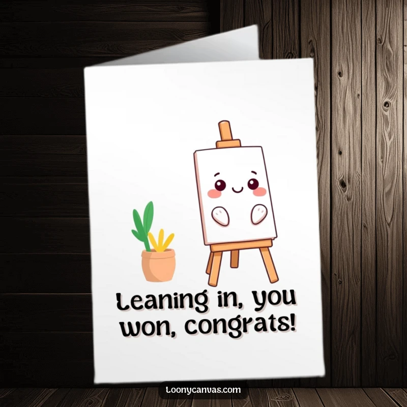 Funny free printable congratulations card: A smiling kawaii easel character leans far to one side, balancing its artwork.